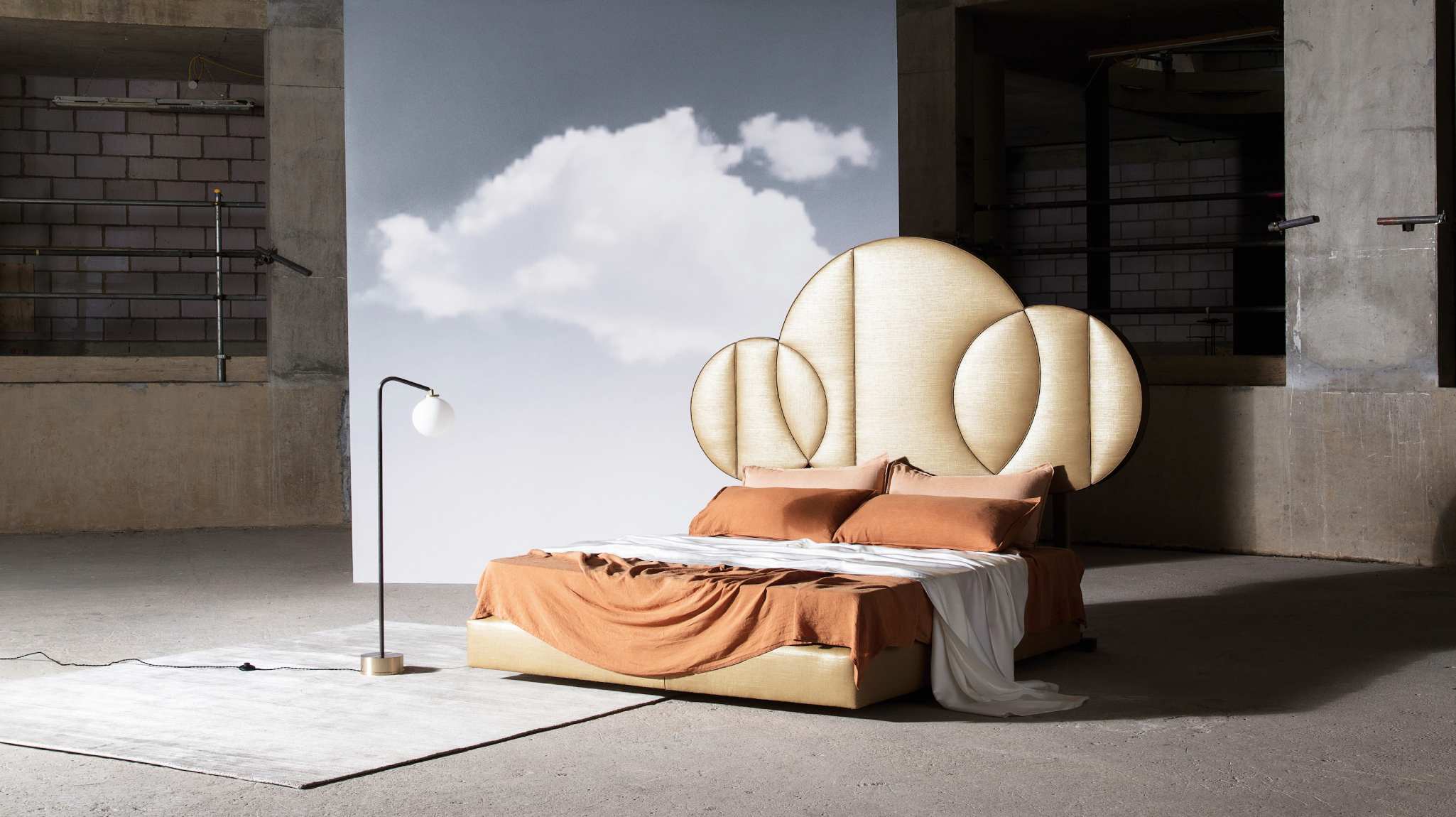 Image of the Moon design featuring the planet shaped headboard, upholstered in silk and dressed in matching bedding.